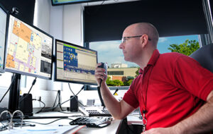 Image of an officer using indoor location data within a 9-1-1 center.